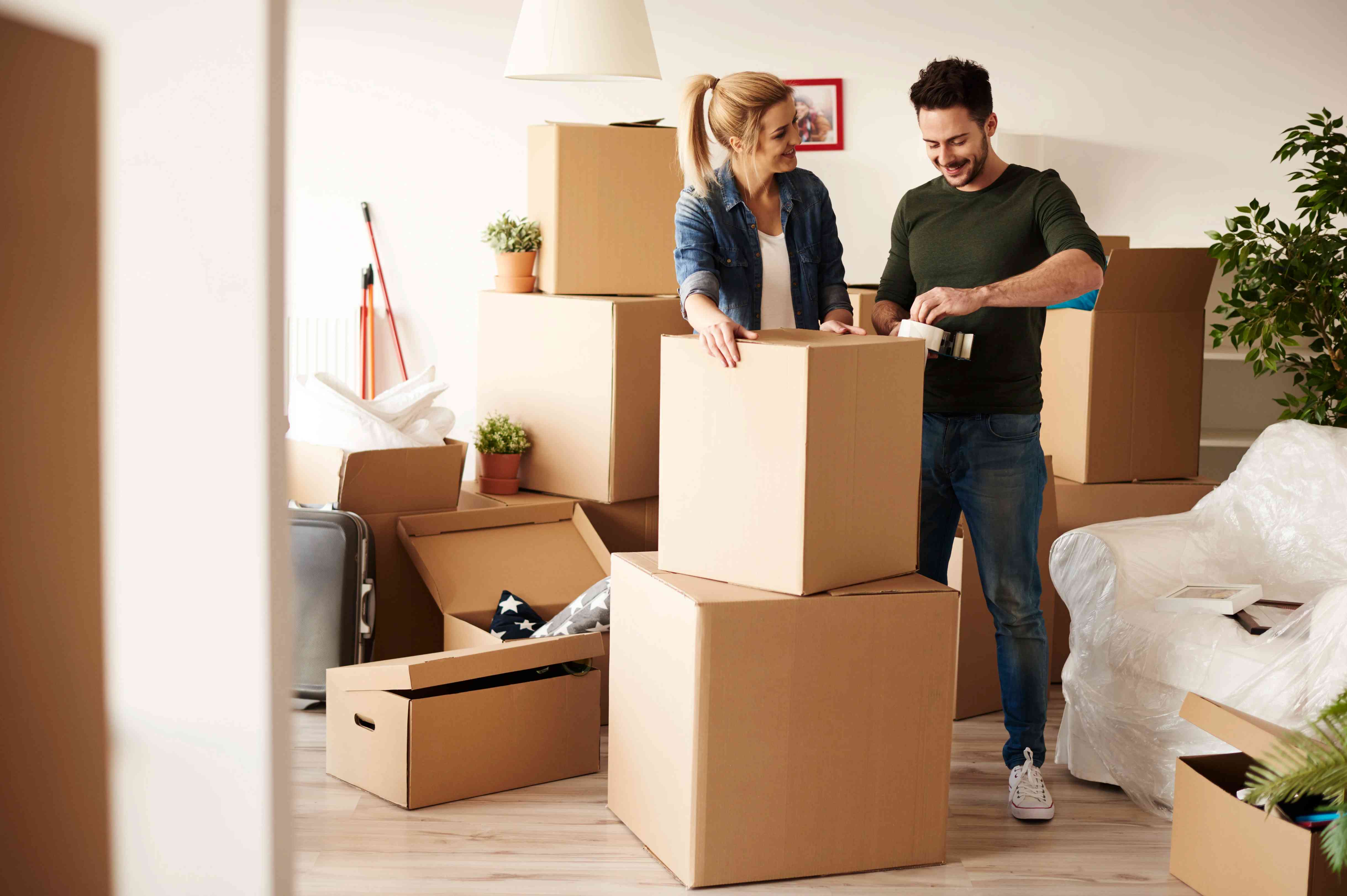 couple-packing-stuff-among-plenty-of-cardboard-boxes